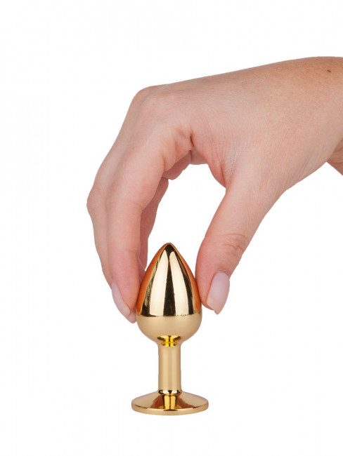 Золотистая анальная втулка с малиновым кристаллом - 7 см. Золотистая анальная втулка с малиновым кристаллом - 7 см.